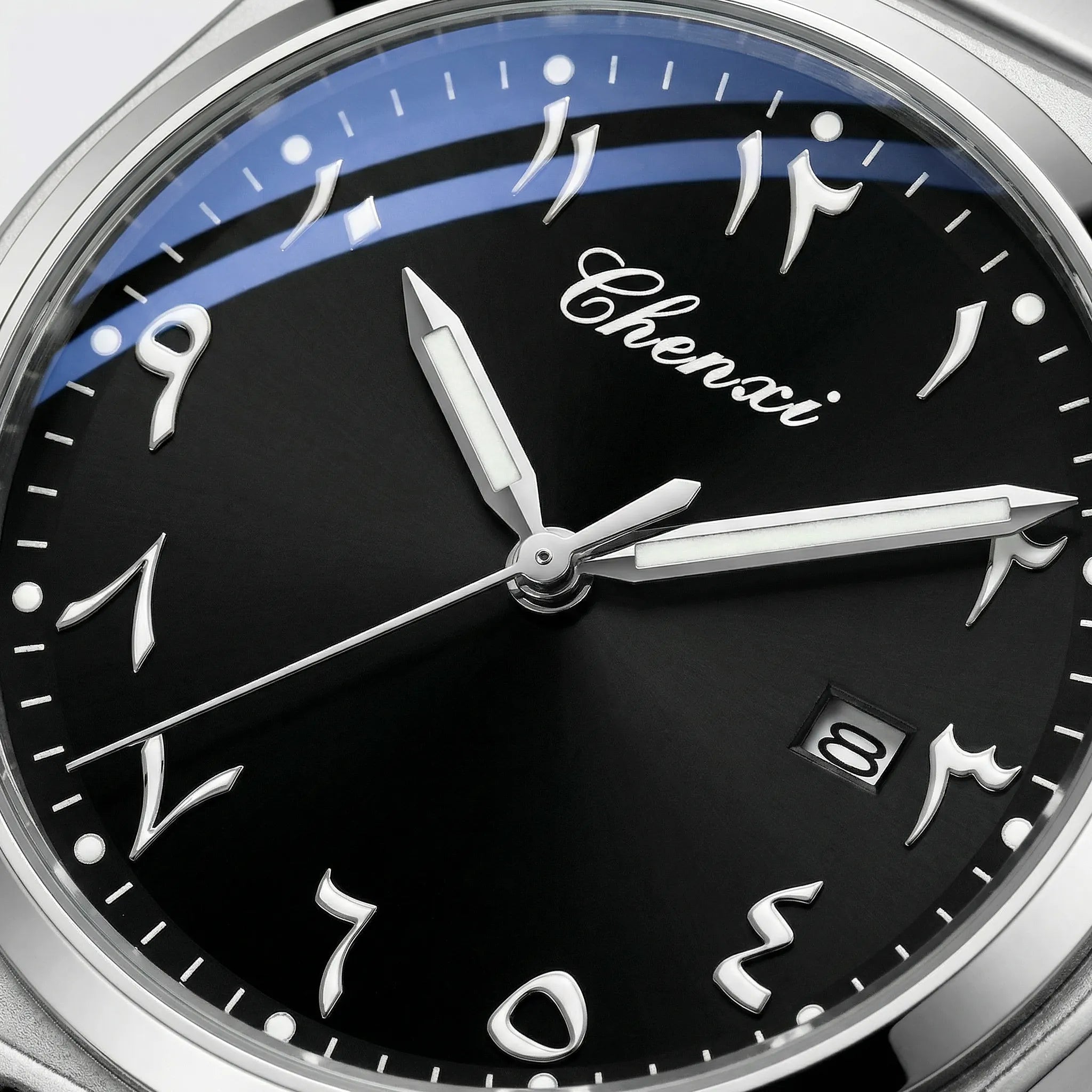 Detailed view of the polished gold tone band on a classic Arabic dial watch.