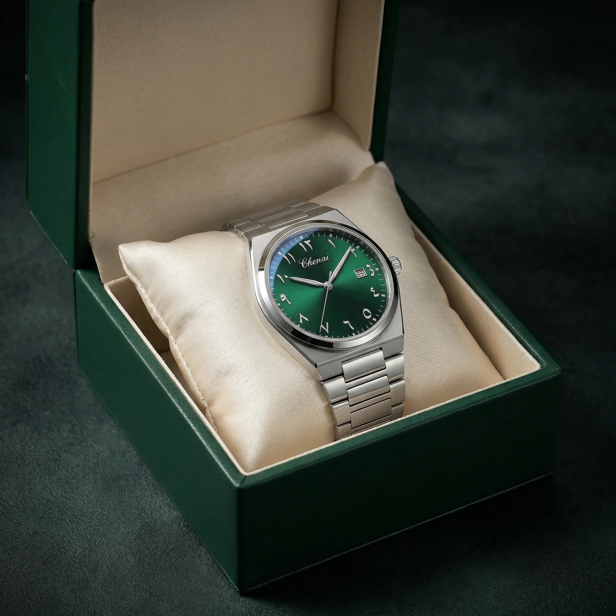 Man wearing a gold tone watch with a green Arabic dial on his wrist, showcasing a luxurious presence.