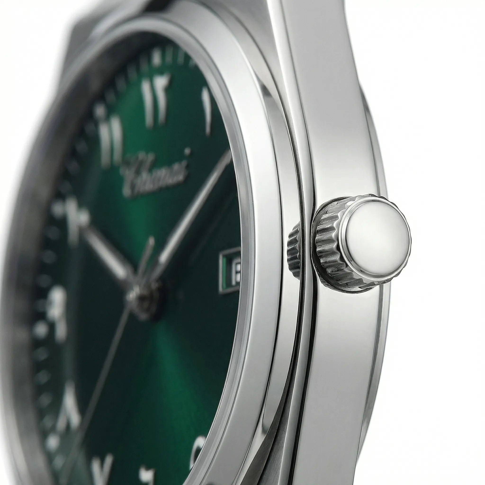 Close-up of the striking green Arabic dial on a gold tone watch, highlighting its precise numerals.