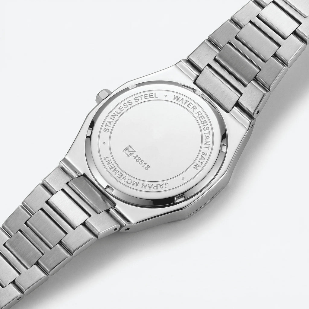 Classic straight-on view of a slim silver watch with an Arabic dial, a timeless accessory.