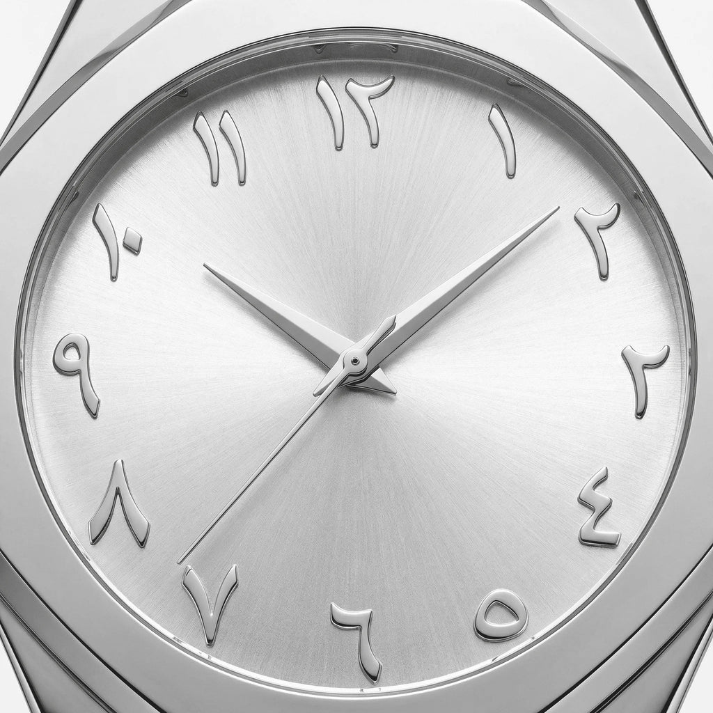 Detailed view of the seamless stainless steel band on a silver Arabic dial dress watch.