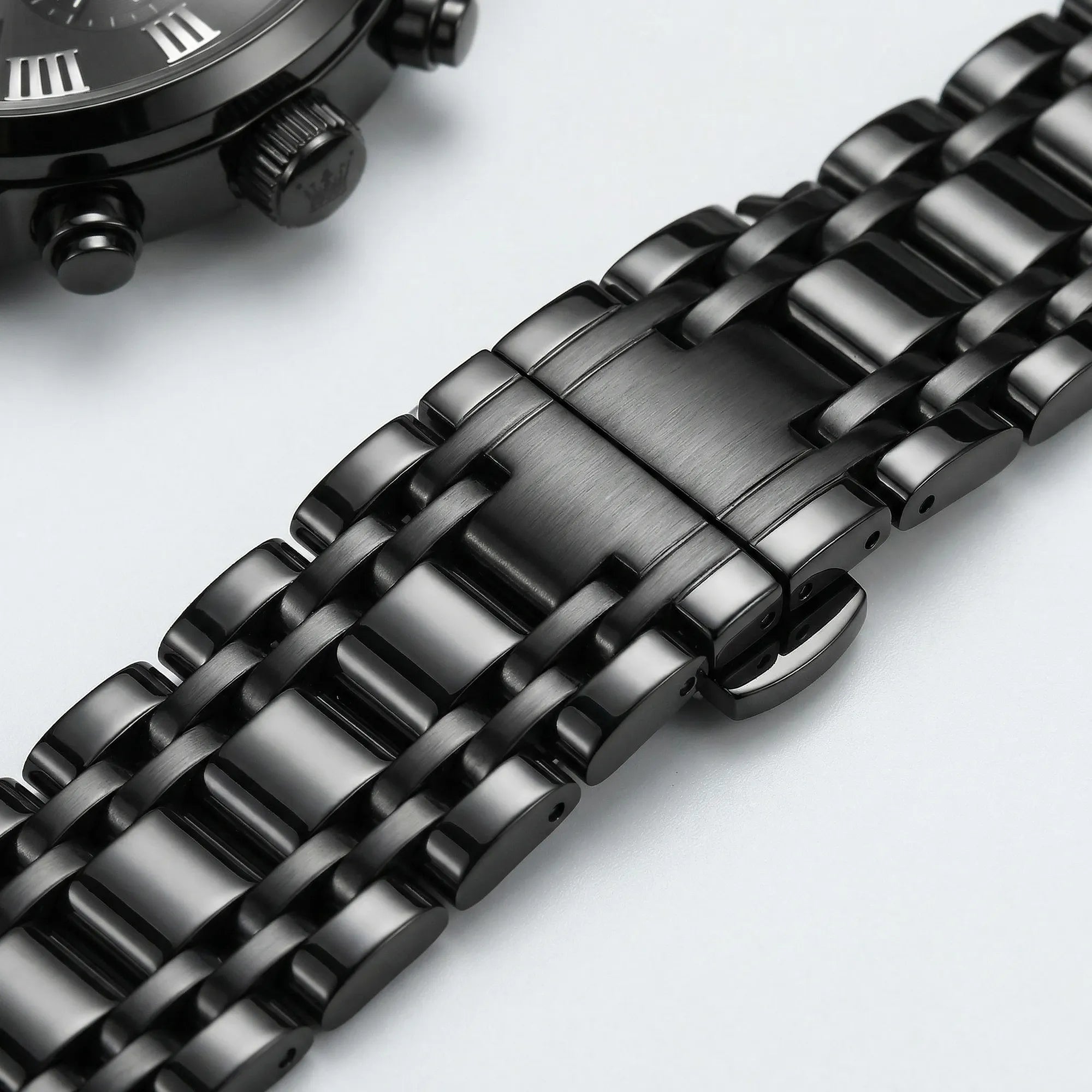 Classic straight-on view of a heavy duty black stainless steel watch, a durable everyday accessory.