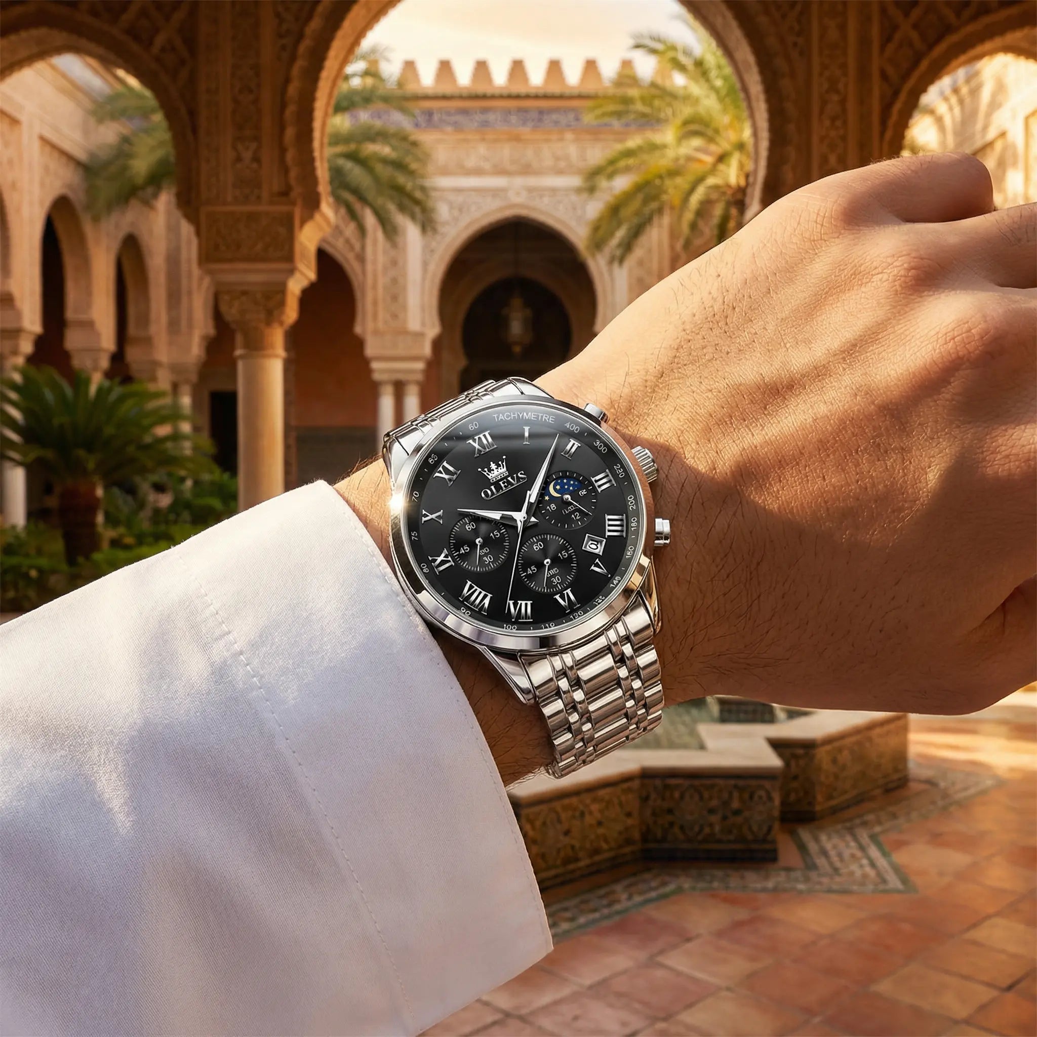 Man wearing a heavy duty silver watch on his wrist, showcasing an uncompromising powerful look.