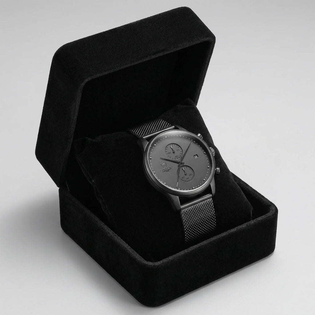 Man wearing a slim gray watch with a mesh band on his wrist, showcasing modern elegance.