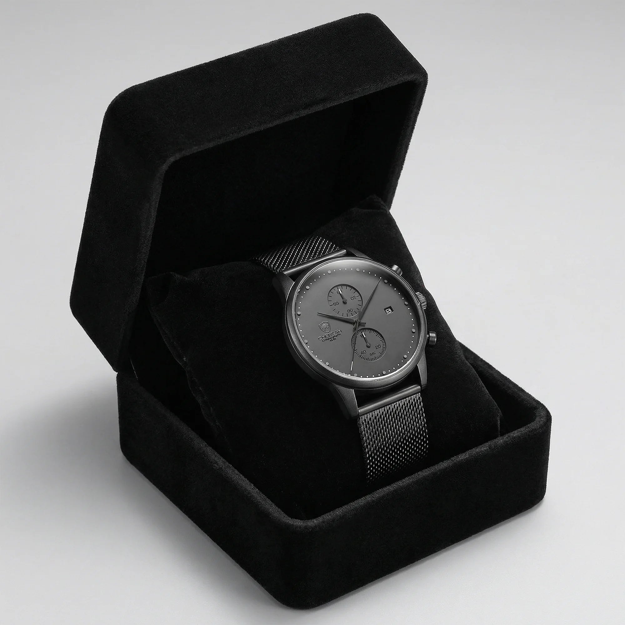 Man wearing a slim gray watch with a mesh band on his wrist, showcasing modern elegance.