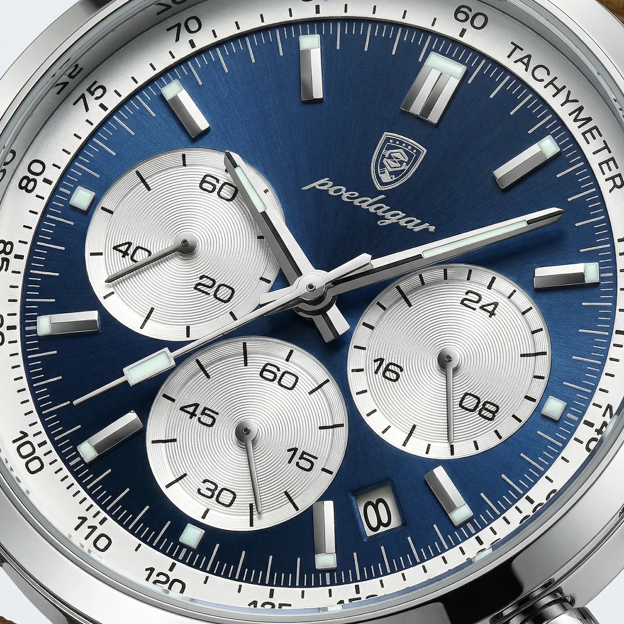 Close-up of the luminous blue dial on a sport watch, highlighting its chronograph functions.