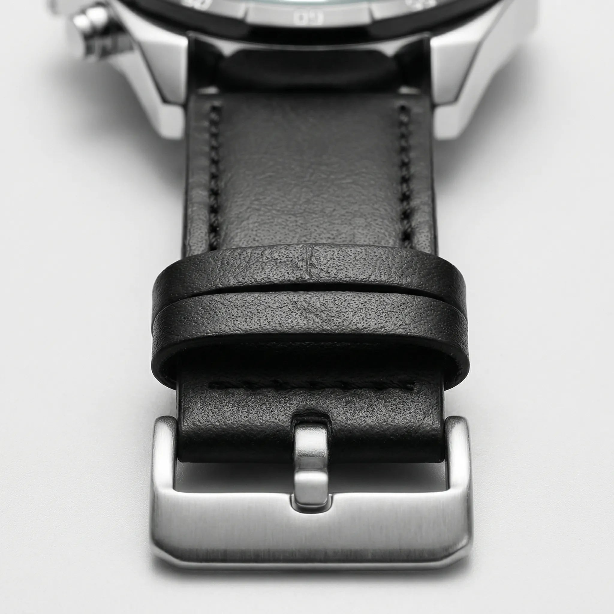 Detailed view of the black leather band on a classic everyday watch, a comfortable accessory.