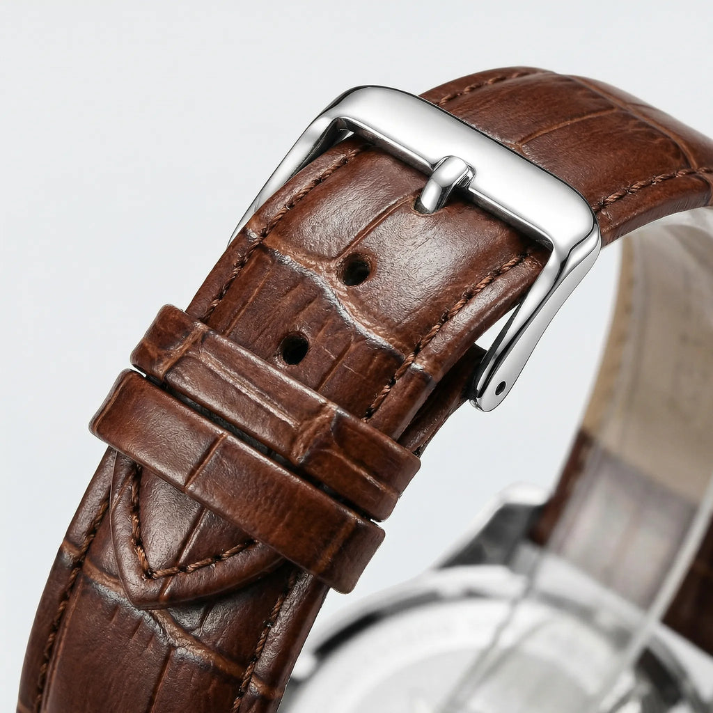 Close-up of the precision hands and sub-dials on a classic heritage white dial watch.