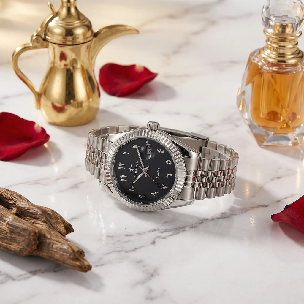 Man wearing a silver business watch with a black Arabic dial on his wrist, an authoritative wrist watch.