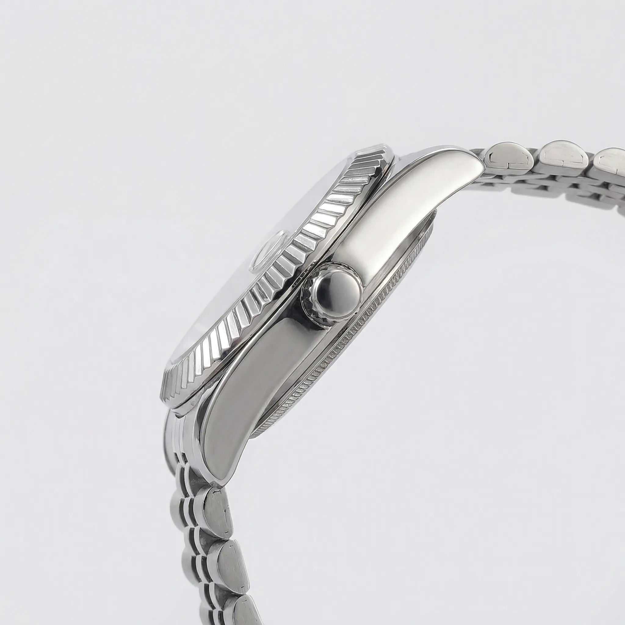 Close-up of the striking black Arabic dial on a silver business watch, a highly legible analog watch.