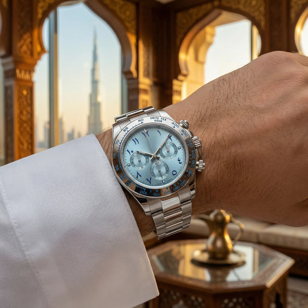 Man wearing a minimalist watch with a white Arabic dial on his wrist, showcasing understated luxury.