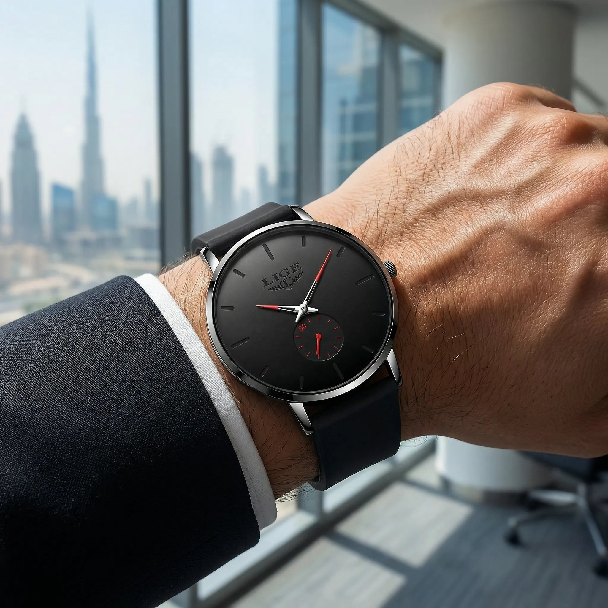 Man wearing a black and red minimalist watch with a mesh band on his wrist, showcasing modern elegance.