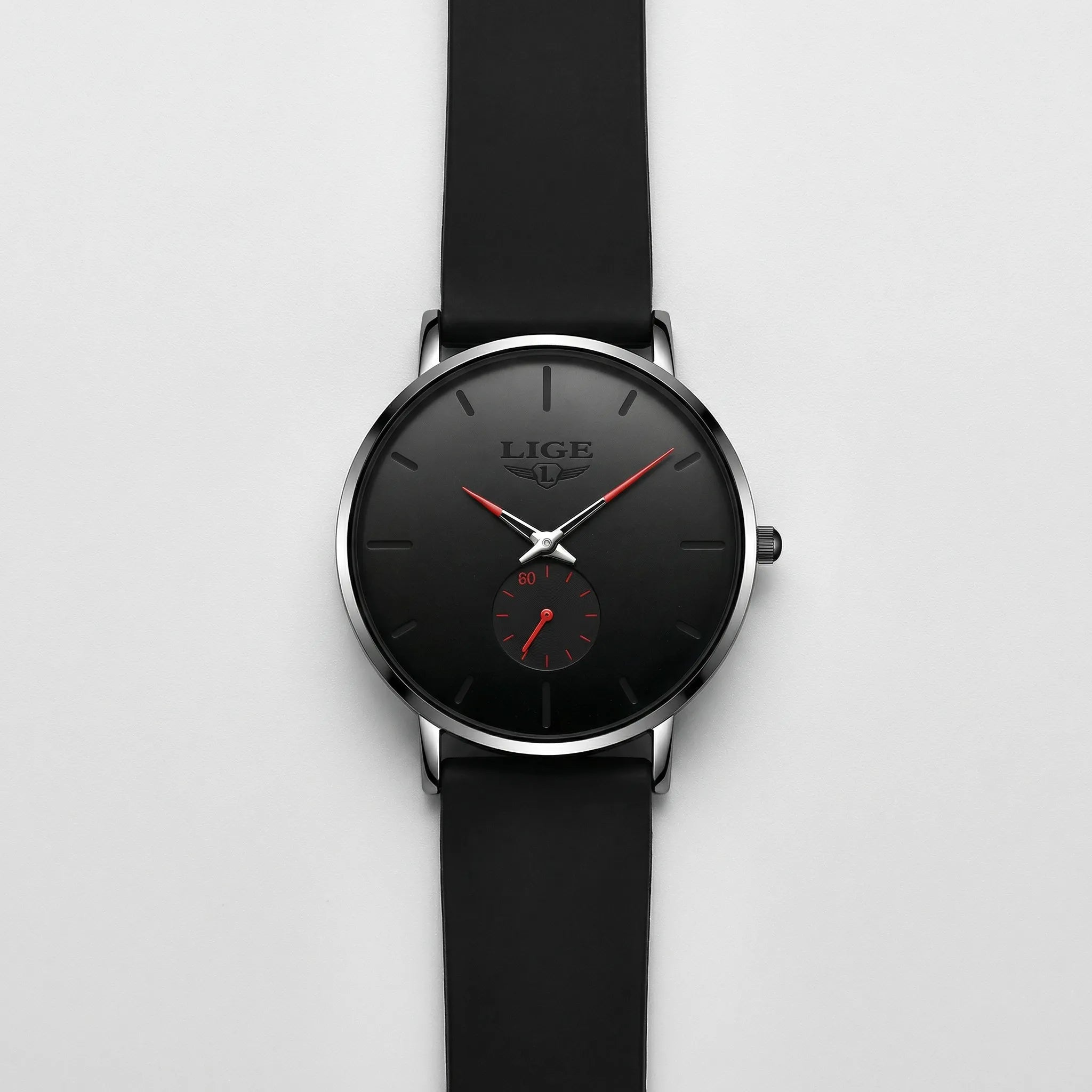 Detailed view of the flexible black mesh band on an ultra-thin minimalist watch with red accents.