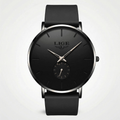 Detailed front view of a minimalist black and rose gold watch with a mesh band, an elegant simple watch.
