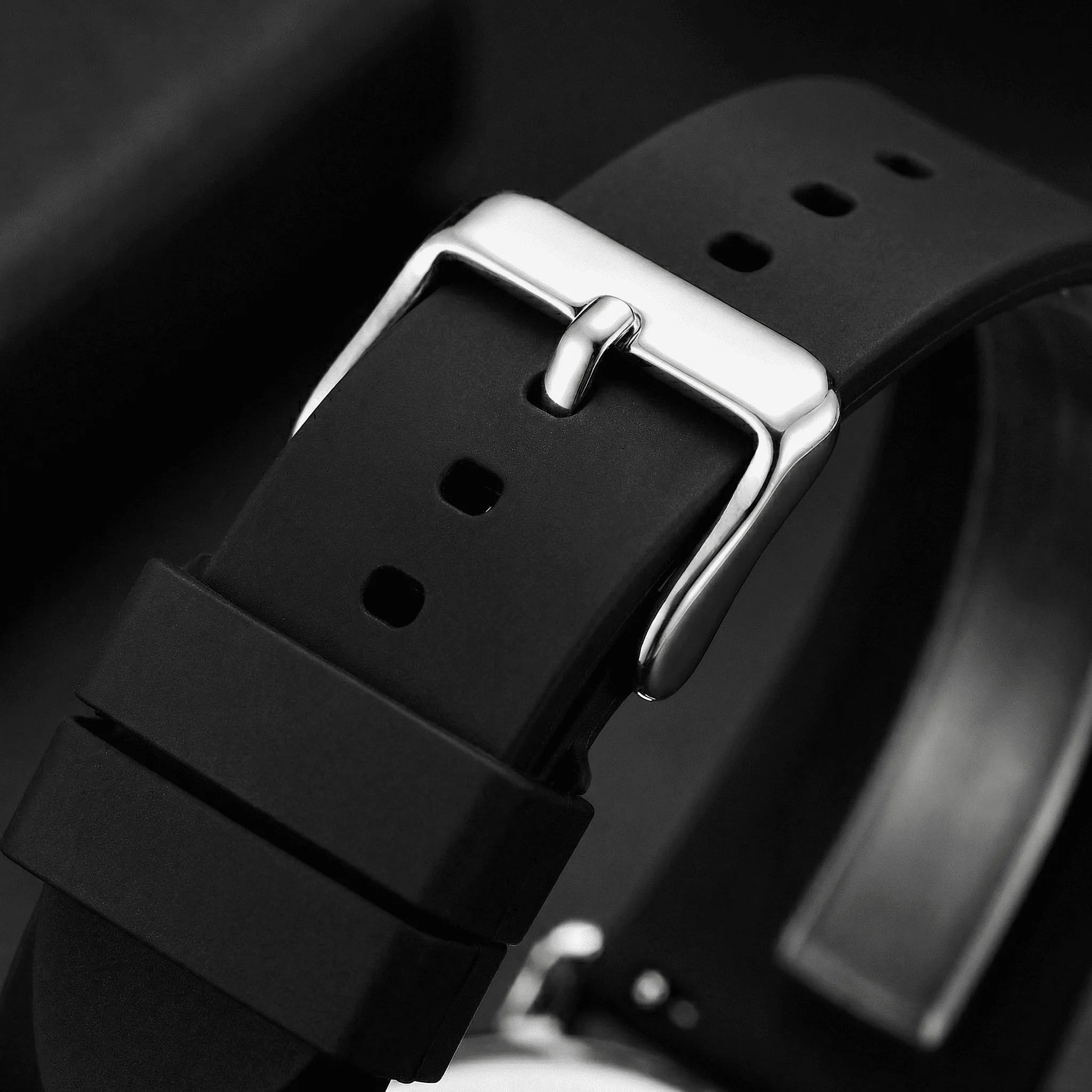 Close-up detailing the refined rose gold accents on a black minimalist watch dial.